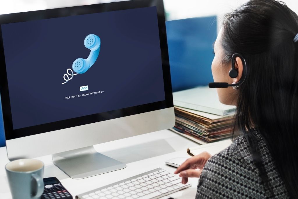 Image showing woman at desk using VoIP system